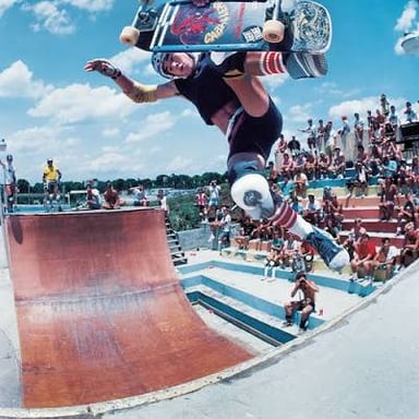 A skateboarder performing a trick at a skatepark.
