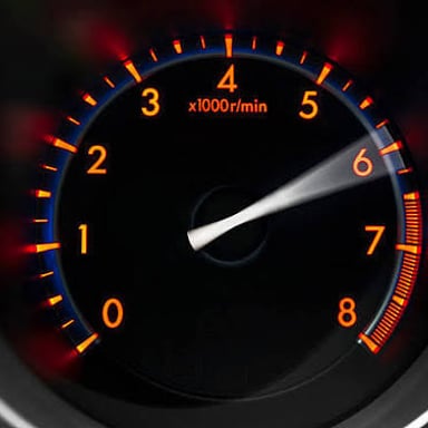 A car engine revving, with the tachometer showing increased engine speed.