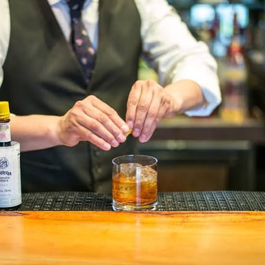 An Old Fashioned cocktail served at a bar.