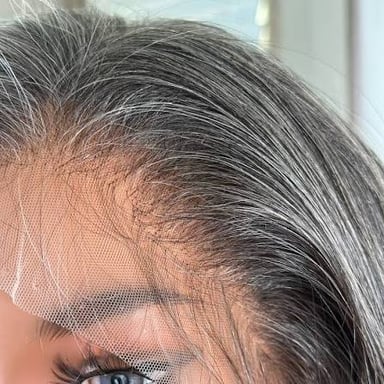 Gray hairs visible among darker strands.