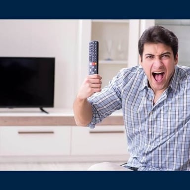A person unplugging a cable from the back of a television.