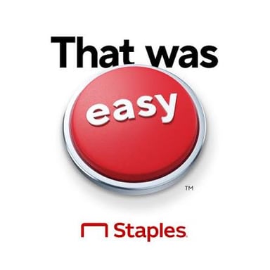 A Staples Easy Button with the word EASY printed prominently on its top.