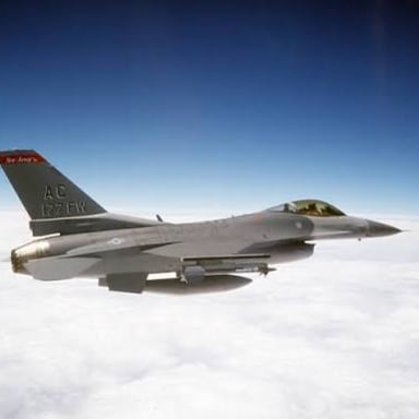 An F-16 Fighting Falcon flying through the air.