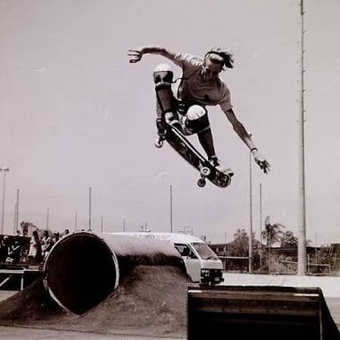 A skateboarder and board airborne during an ollie.