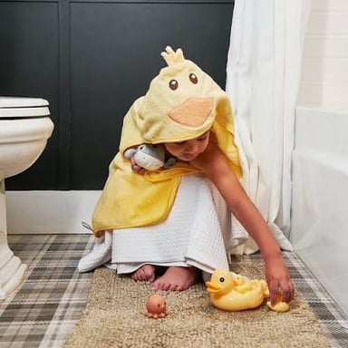 Bath toys and a towel suggest a child's bath as part of a bedtime routine.