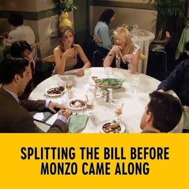Diners dividing a restaurant bill at a table.
