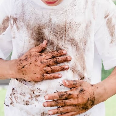 A dark mud stain marking white fabric