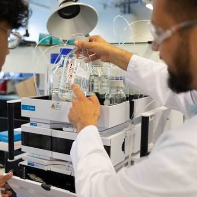 A scientist conducting research in a laboratory, within a field of study.