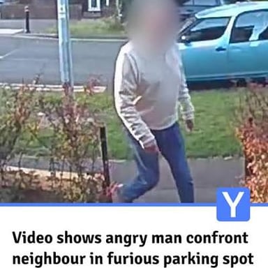 An angry person confronting another person in an aggressive stance.