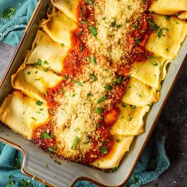 A spread of Italian antipasti, baked manicotti pasta, and gelato.