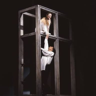 A theatrical depiction of Romeo and Juliet in a romantic scene.