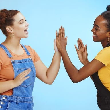 Two people meeting raised hands for a high five
