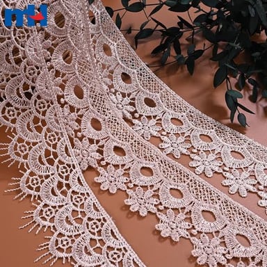 Close-up of lace fabric showing its delicate openwork pattern.