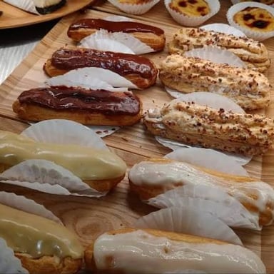 An éclair, an elongated choux pastry filled with cream and topped with icing.