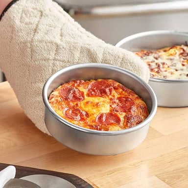A deep-dish pizza baked in a round pan
