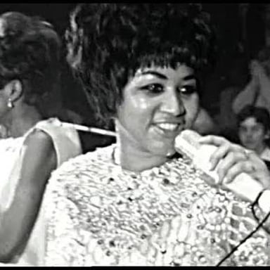 Aretha Franklin performing onstage.
