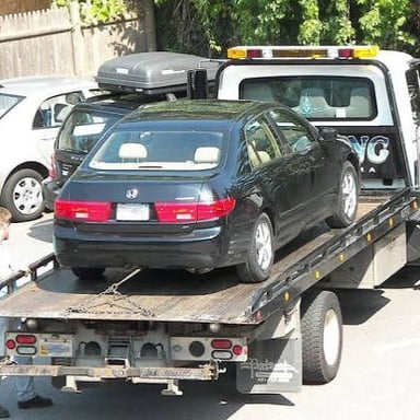 A car being taken away during a repossession.