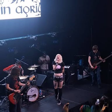 A rock band performing an intense live screamo set