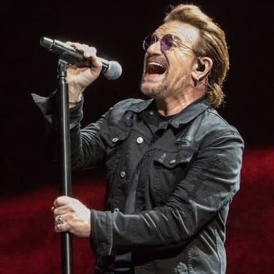 Bono performing with U2 onstage.