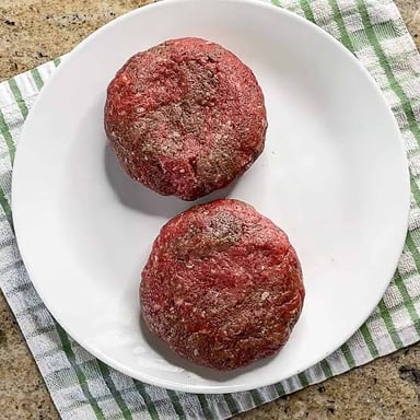 A round patty made from ground beef