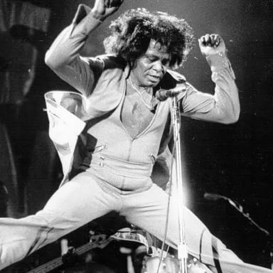 James Brown performing with a band, illustrating the music genre associated with his recordings.