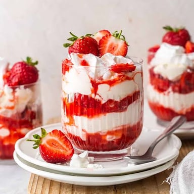 Eton mess served with strawberries, whipped cream, and pieces of meringue.