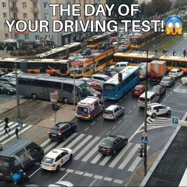 A car being driven on a public road during a driving test.