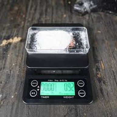 A small mass labeled one gram on a precision scale