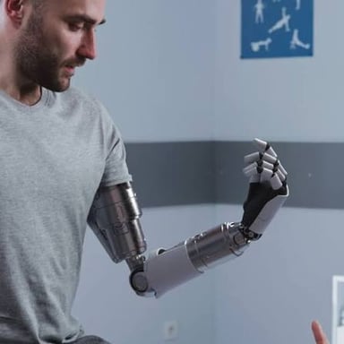 A person using a prosthetic limb with electronic or mechanical features.