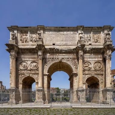 A stone triumphal arch with a broad curved opening through its center.
