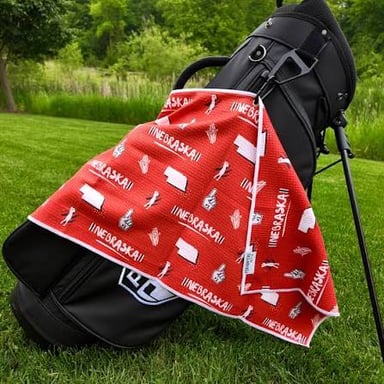 A golf bag with a towel clipped to its side.