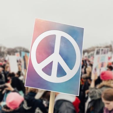 People walking together at a peace march, some carrying signs.