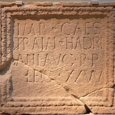 The Roman numeral I displayed in an ancient-style inscription