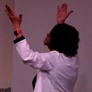 A person speaking emphatically while making a declaration