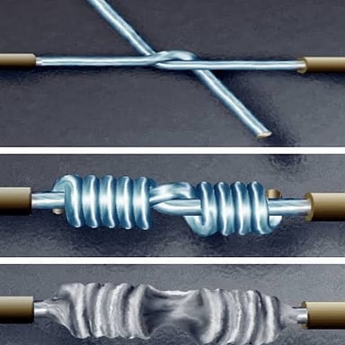 A soldering iron joining two metal surfaces.