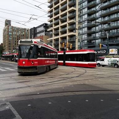 A tram traveling along urban street tracks.