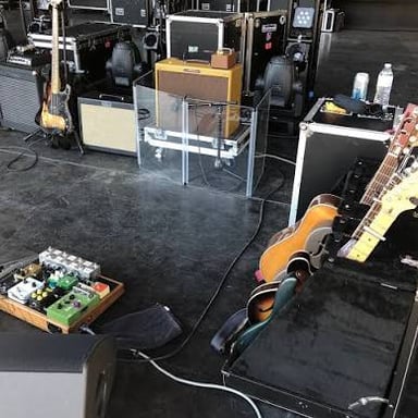 A guitar amplifier set up beside a performer at a concert.