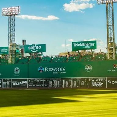 The Boston Red Sox at Fenway Park, with the Green Monster visible in left field.