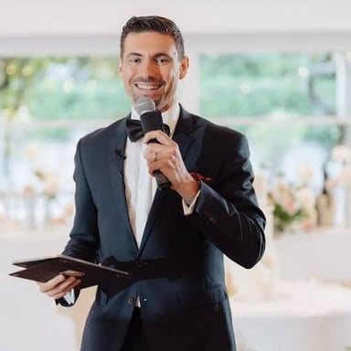 A master of ceremonies hosting an event with a microphone.