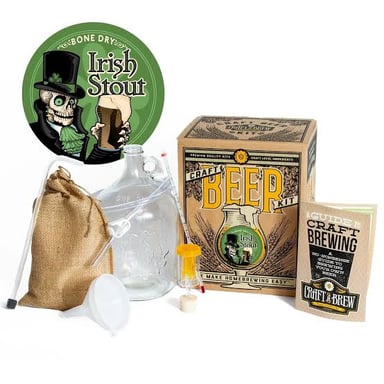 A brewer working with dark stout beer in a brewery.
