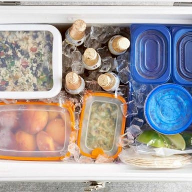 Bottles and food kept cold in a container of ice.