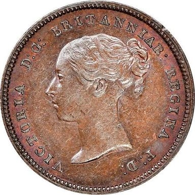 A British halfpenny coin shown with farthing coins.