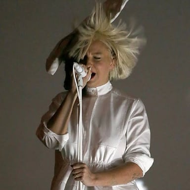 Singer Sia performs with a wig covering much of her face.