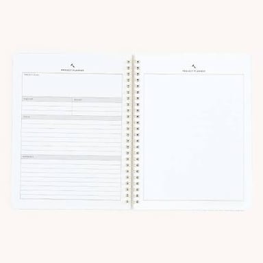 A person beginning a new project in a blank notebook.