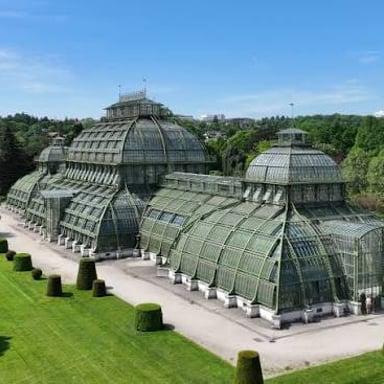 The Palm House, a historic glasshouse at Kew Gardens in London.