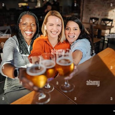A group of people raising drinks together.