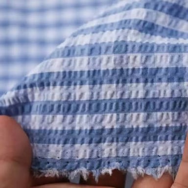 Gingham’s checks and seersucker’s puckered texture show two different kinds of cloth.