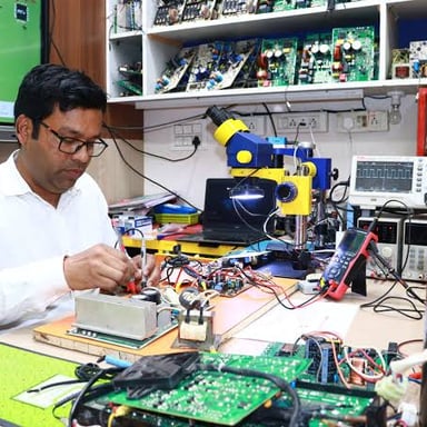 An electrical engineer examines an electronic circuit board.