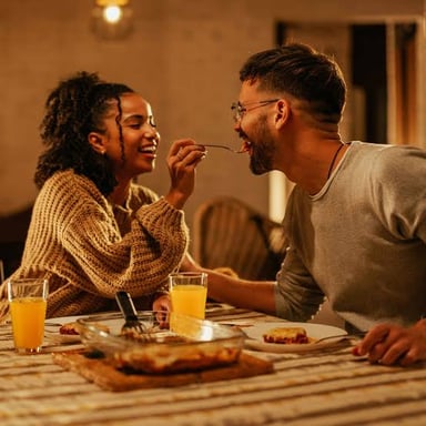 A couple sharing dinner on a weekend evening.