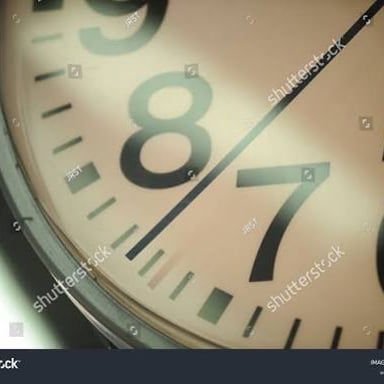 A close-up of a clock showing its second hand